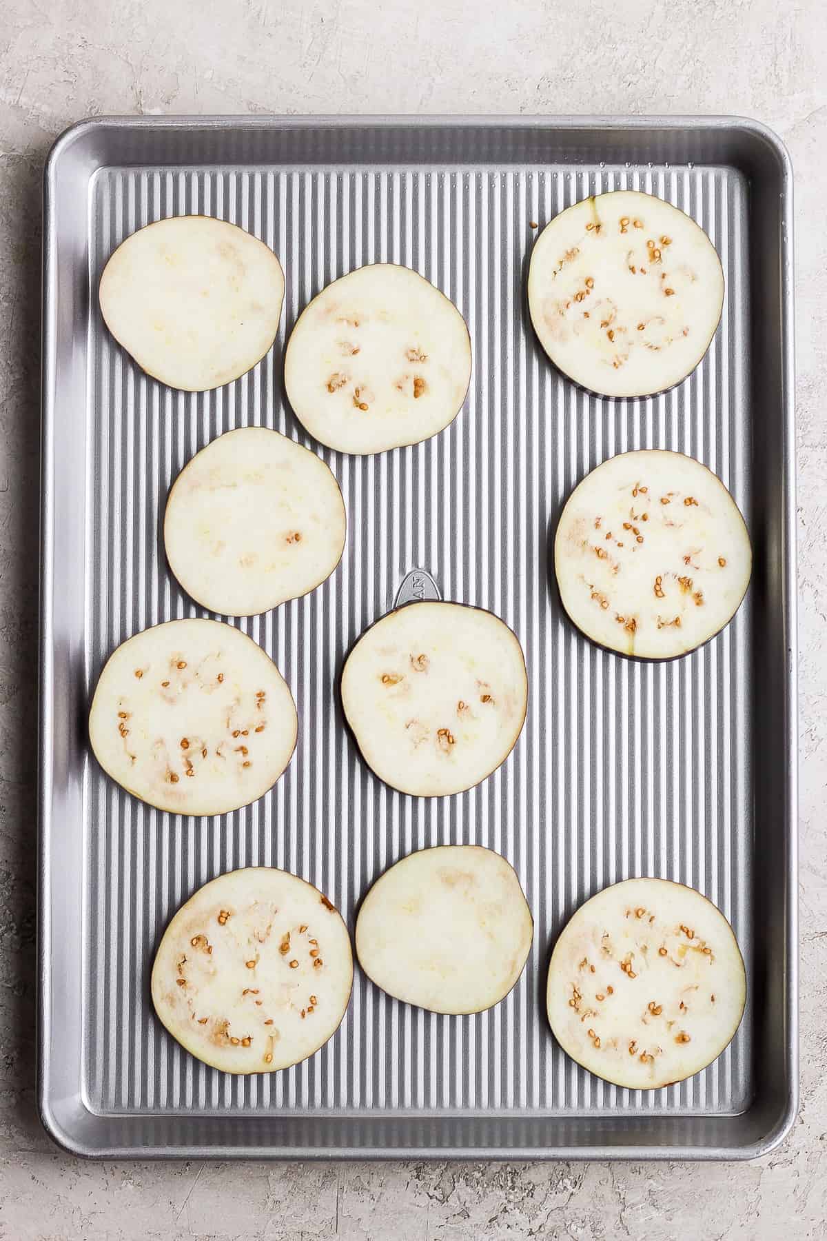 Salted eggplant on a baking sheet.