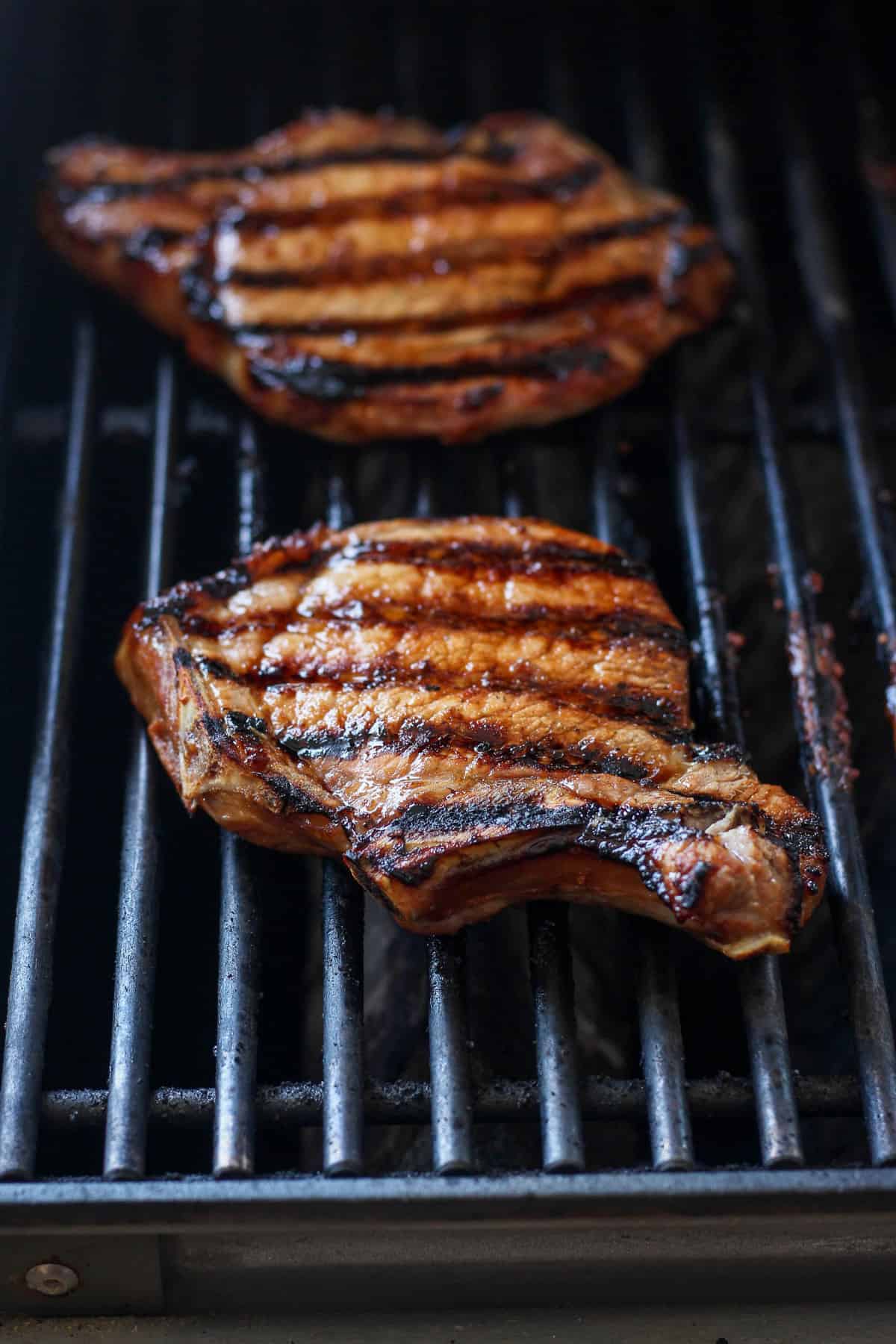 pork chops grilling on grill.