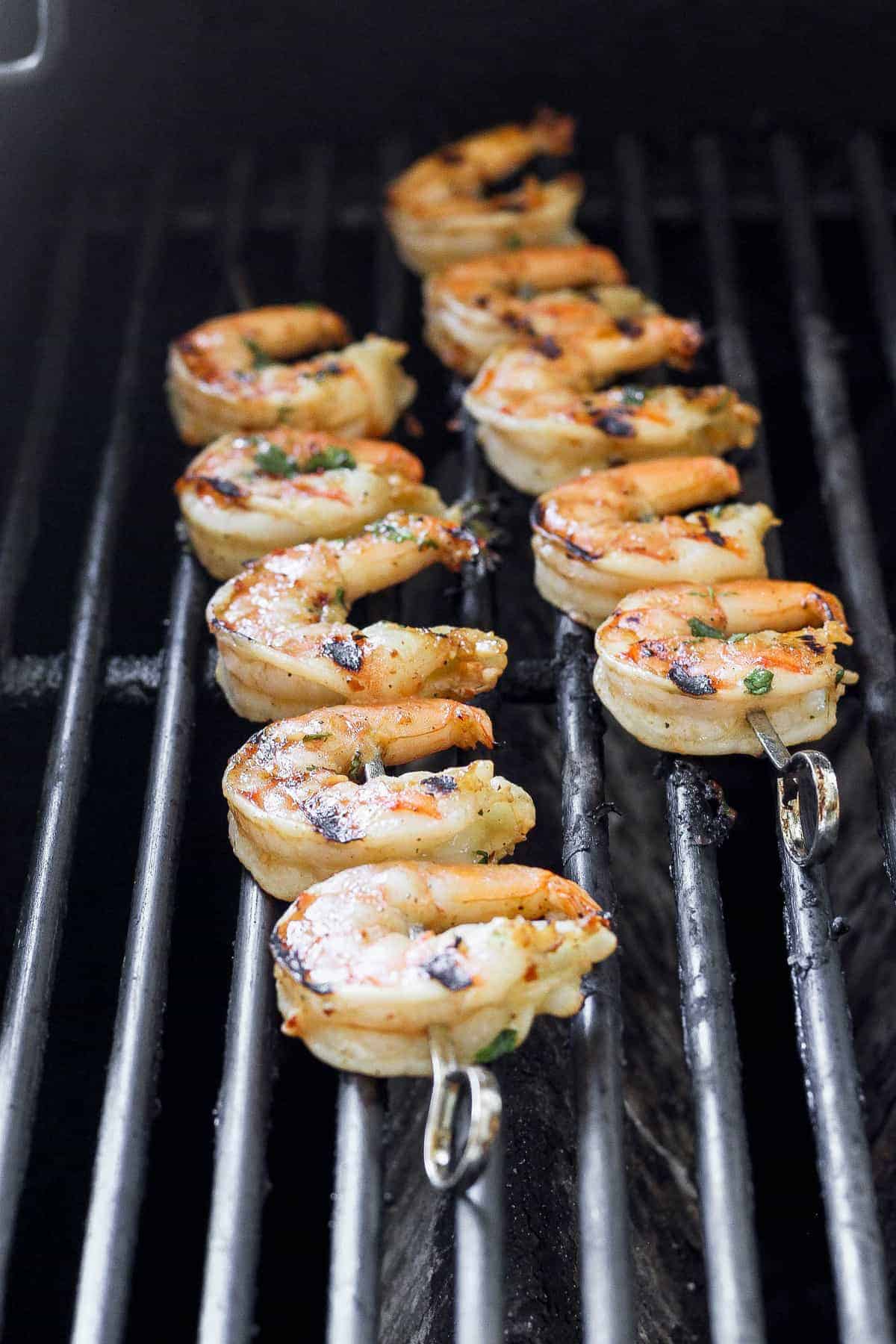 Grilled shrimp on skewers on the grill.