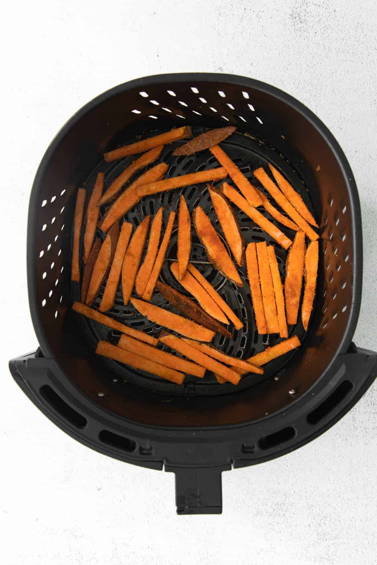 air fryer sweet potato fries in the air fryer basket