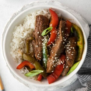 Pepper steak sprinkled with sesame seeds.