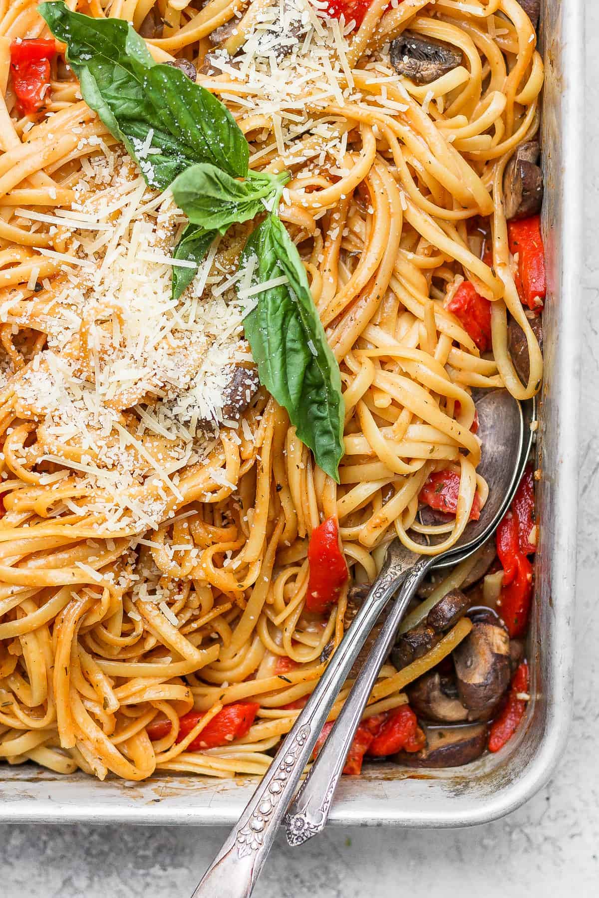 Baked one pot pasta topped with parmesan and fresh basil. 