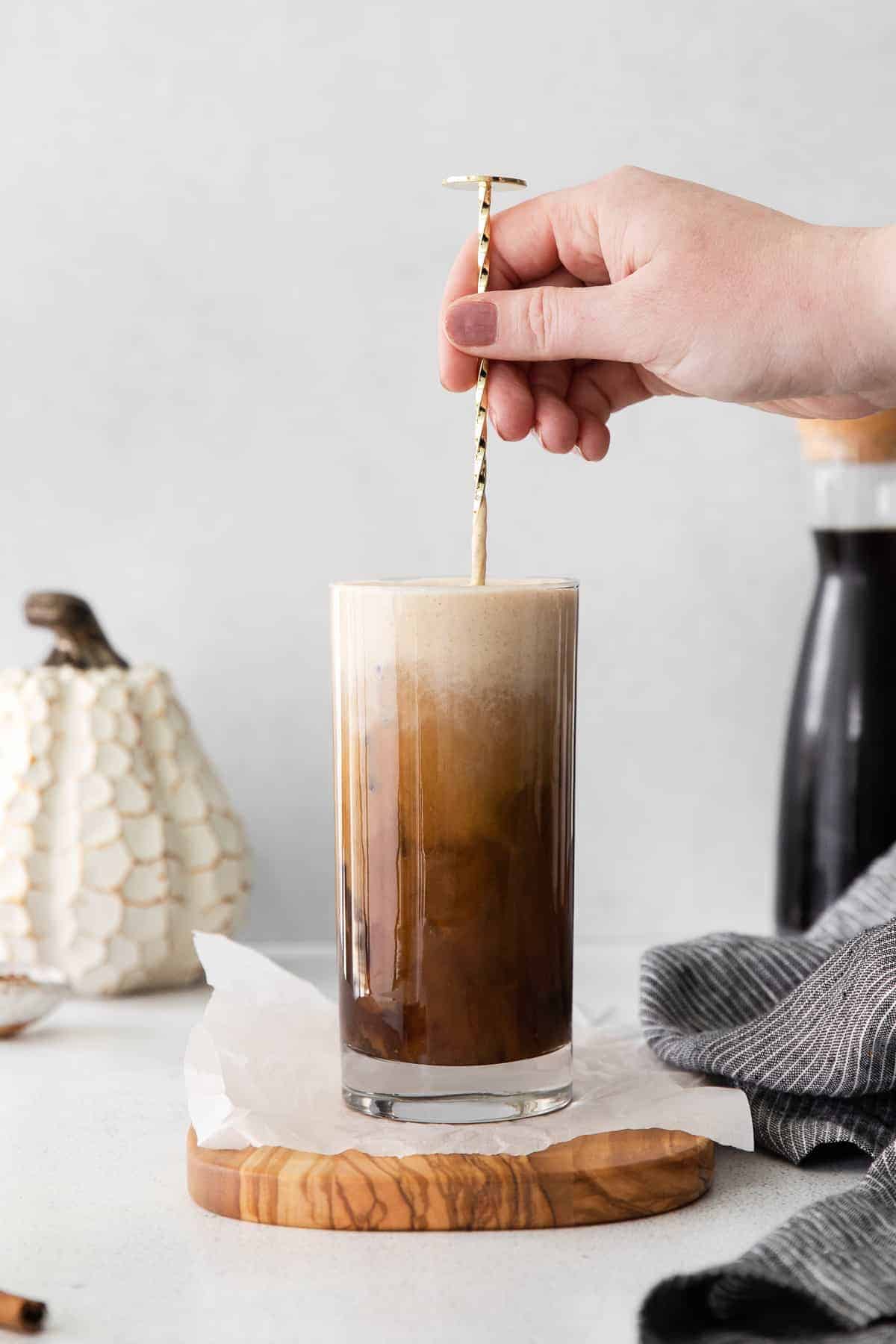 Mixing up Pumpkin Cream Cold Brew with a straw. 