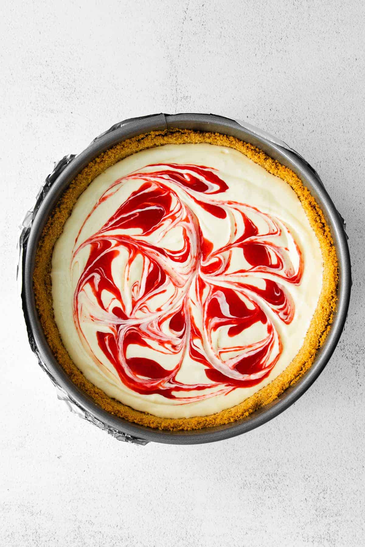 greek yogurt cheesecake topped with raspberry swirl