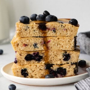 a stack of blueberry pancakes on a plate.