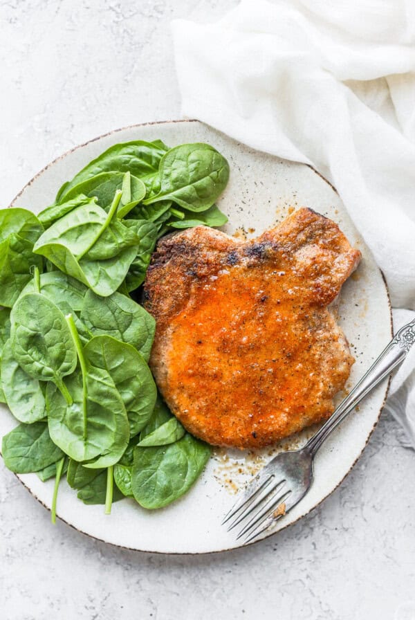 pork chop and spinach on plate