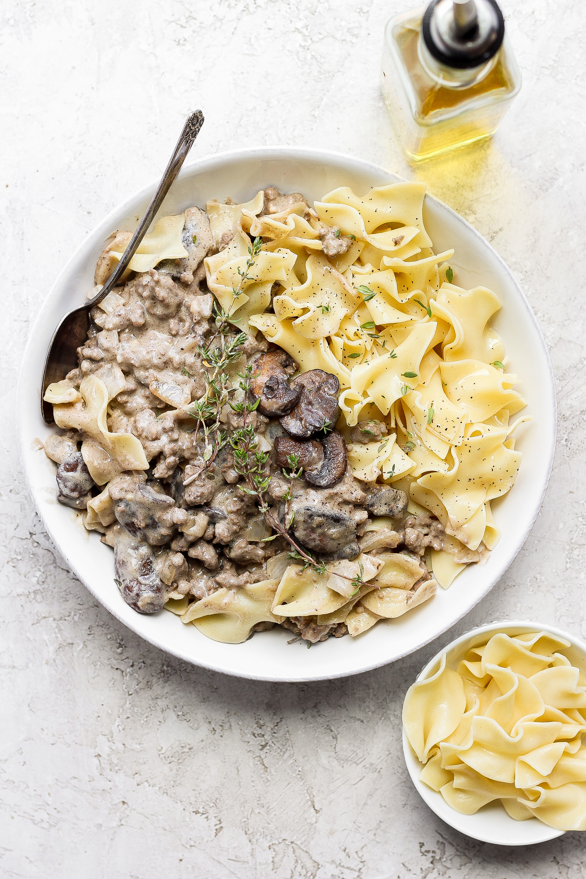 ground beef stroganoff in a bowl topped with fresh thyme