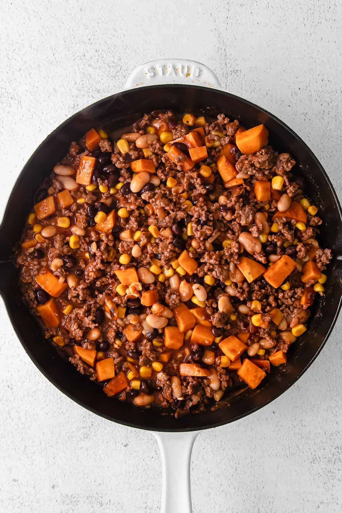 enchilada skillet ingredients in a cast iron skillet