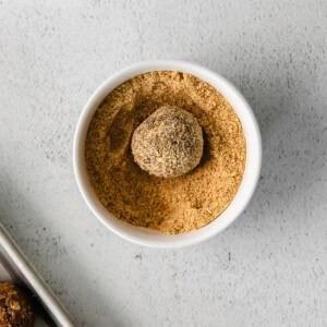 a bowl of peanut butter with a spoon next to it.