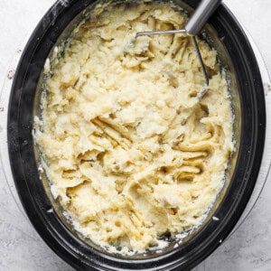 A bowl of mashed potatoes in a slow cooker.