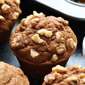 pumpkin muffins with walnuts on counter.