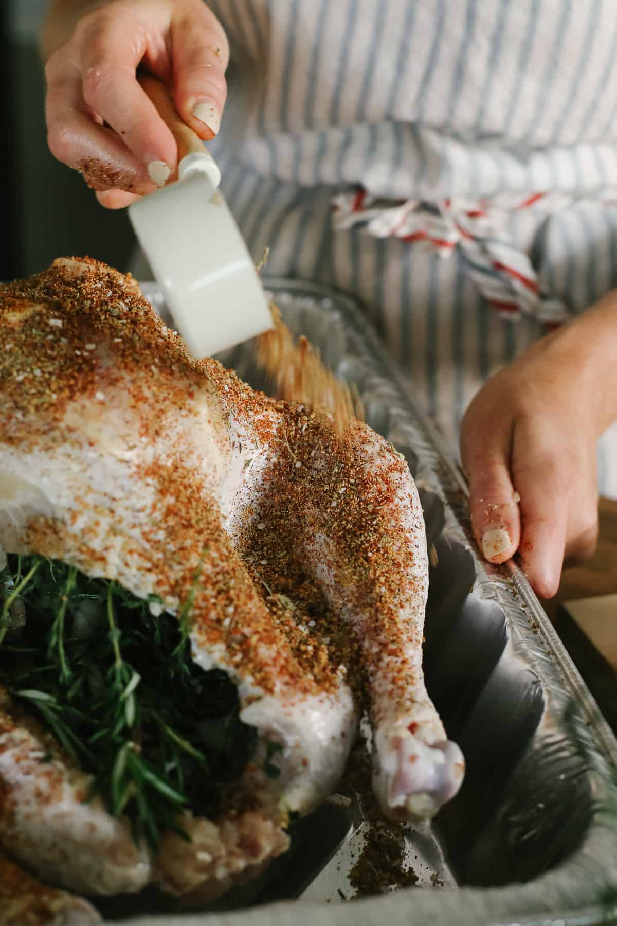 Seasoning a turkey to smoke. 