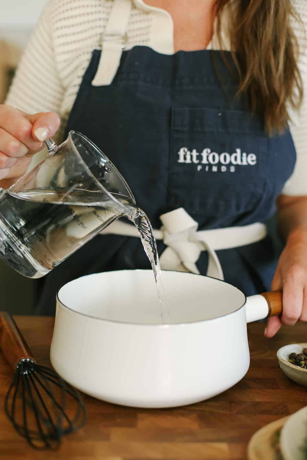 Adding water and salt to a small saucepan. 