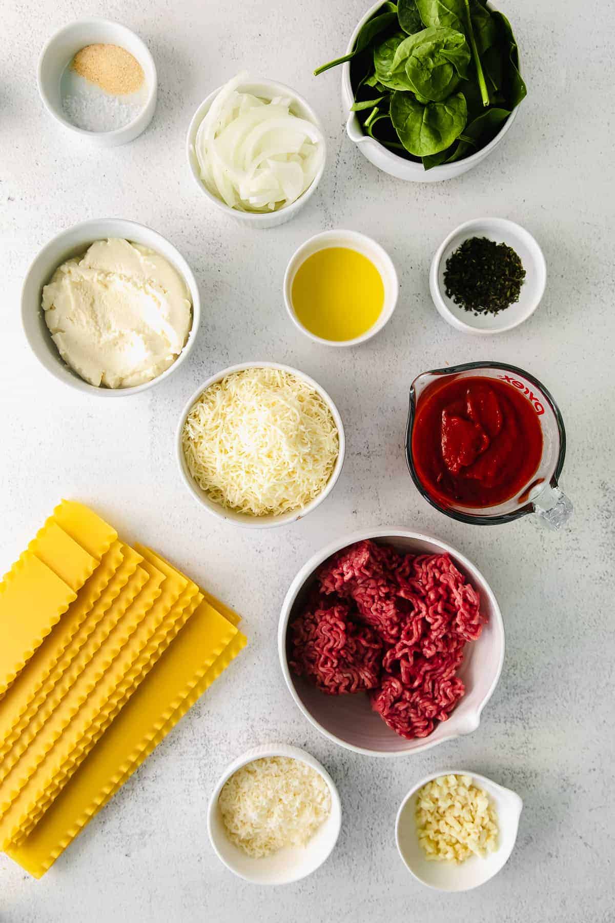 All of the ingredients for lasagna roll ups on the kitchen counter. 