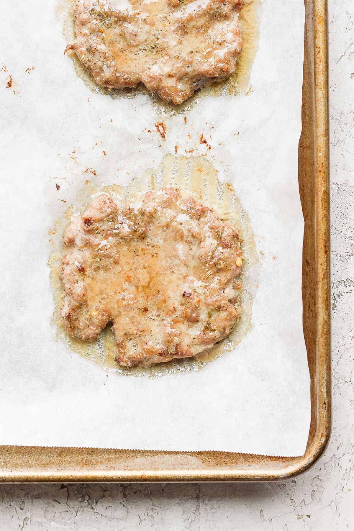 cooking breakfast sausage on baking sheet