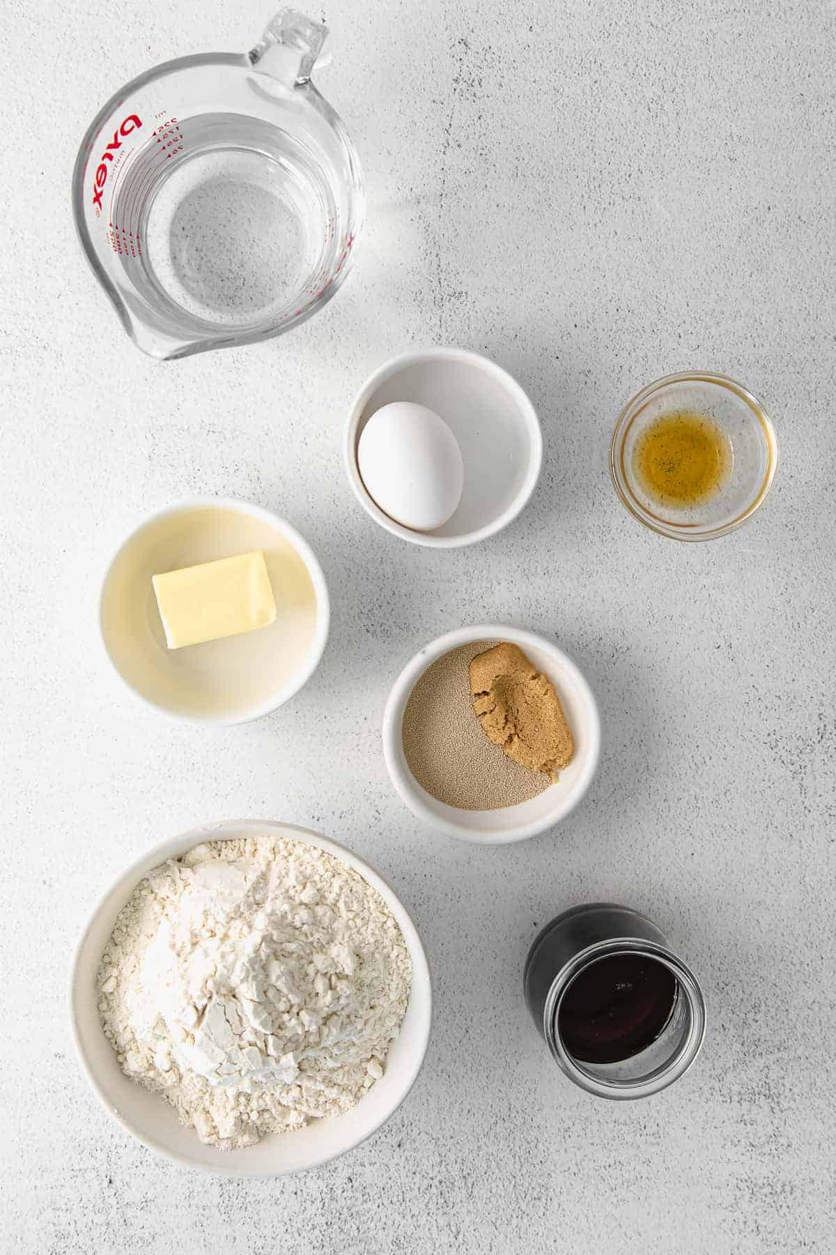 ingredients for maple cinnamon rolls in small bowls