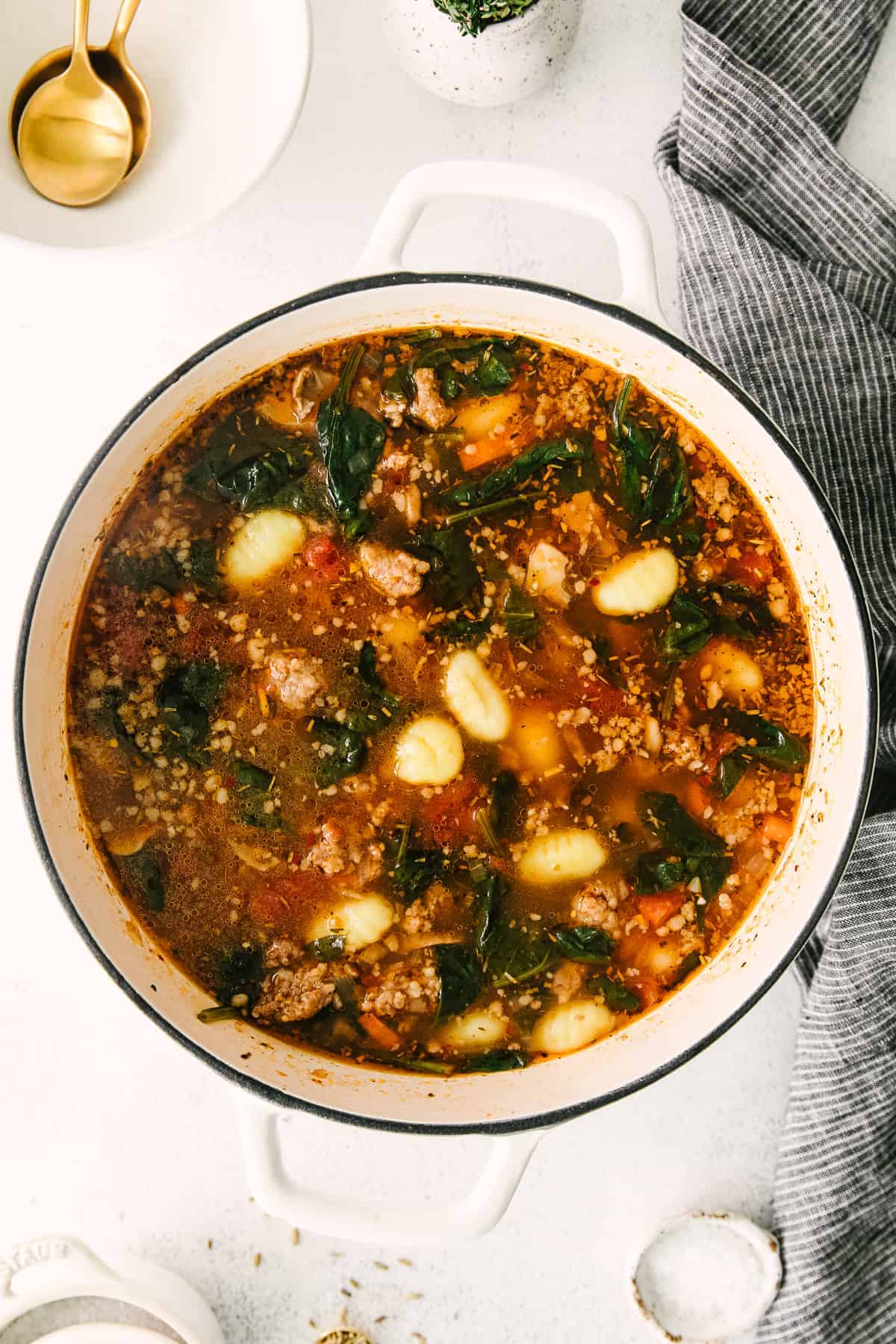 sausage gnocchi soup in a stock pot with gnocchi starting to rise to the top