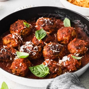 Meatballs in tomato sauce in a skillet.