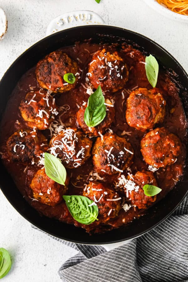 Meatballs in tomato sauce in a skillet.