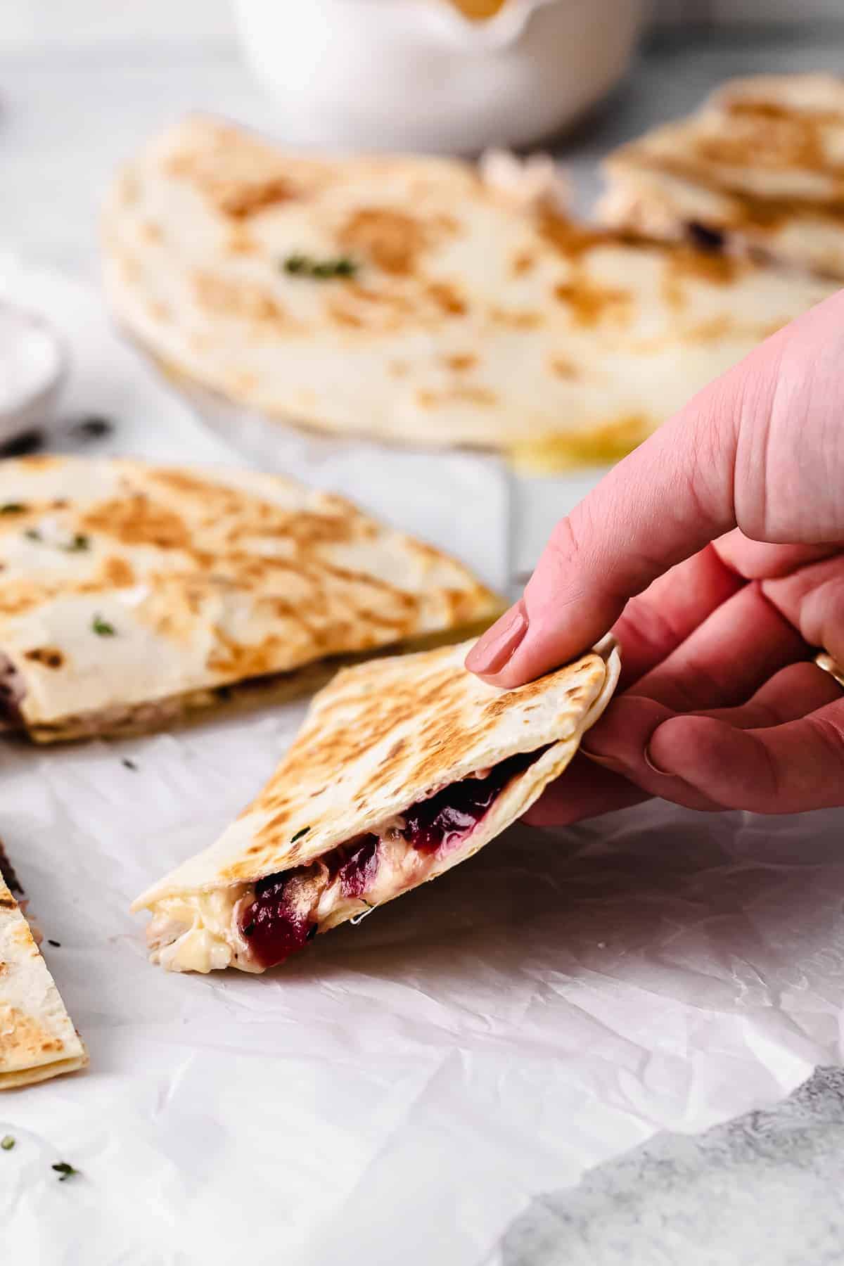 leftover thanksgiving turkey quesadilla in someone's hand