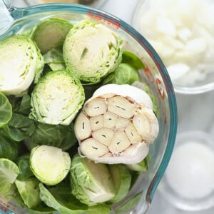 Roasted brussels sprouts in a glass bowl.