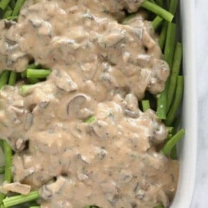 Mushrooms and green beans in a casserole dish.