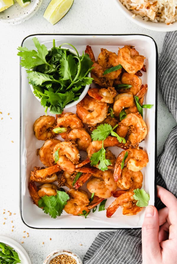 Shrimp cooked and garnished on a tray.