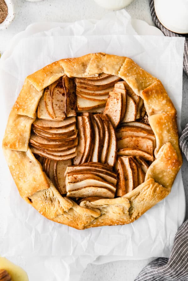 A slice of apple pie on a piece of paper.