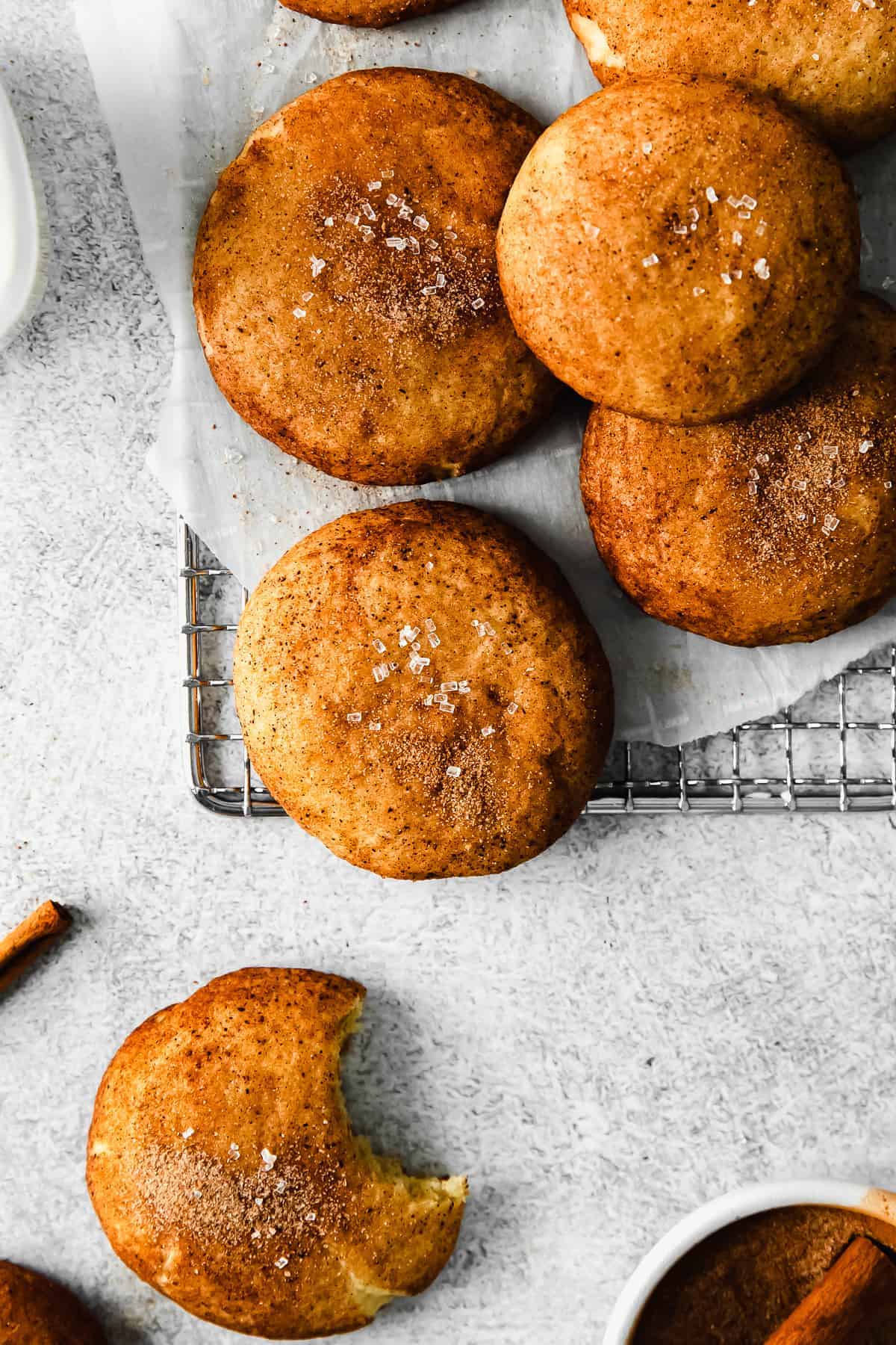 Baked snickerdoodles on a wire rack. 