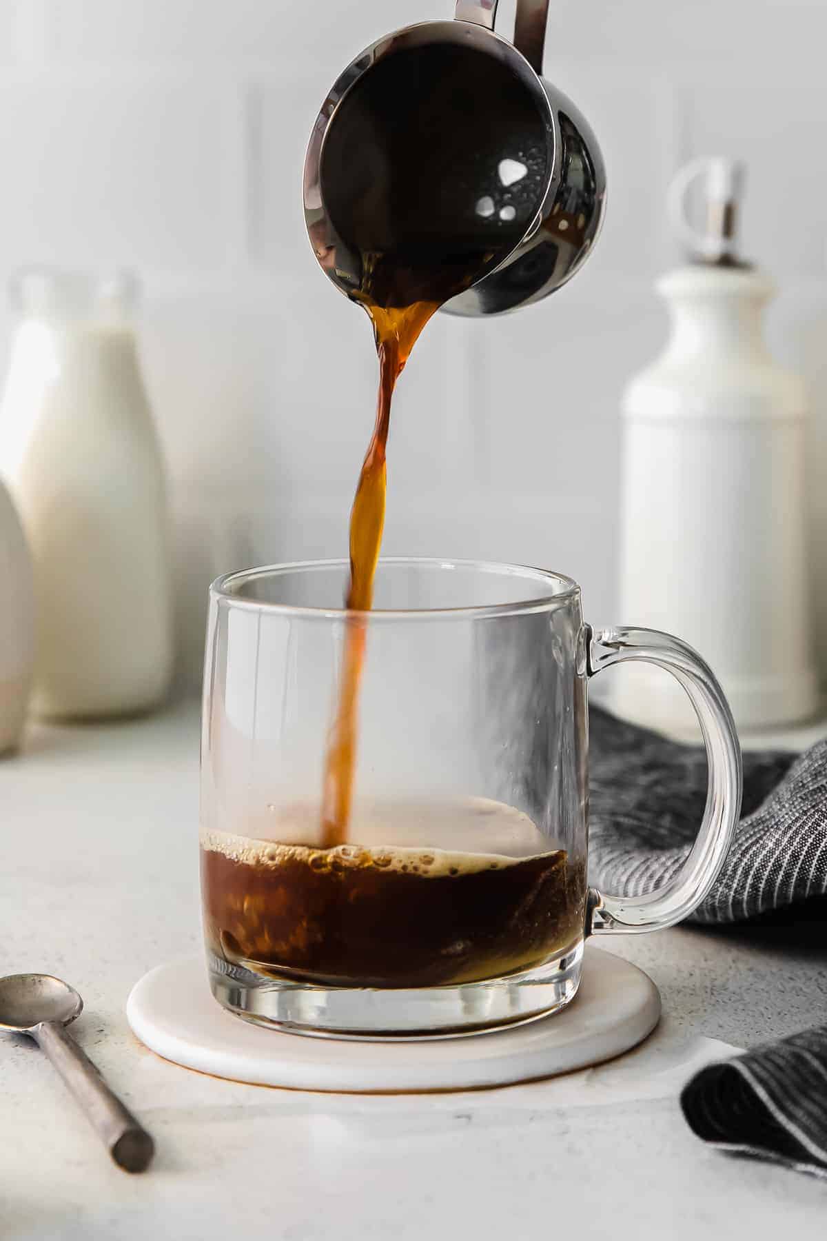 pouring espresso into glass