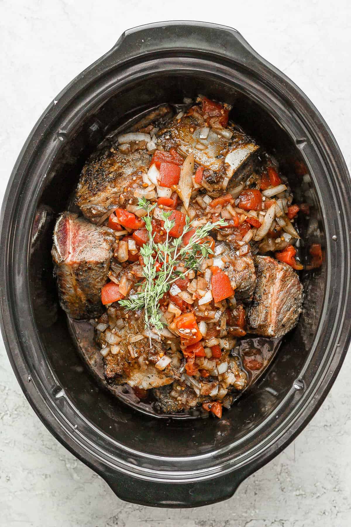 ingredients for short rib ragu in a slow cooker