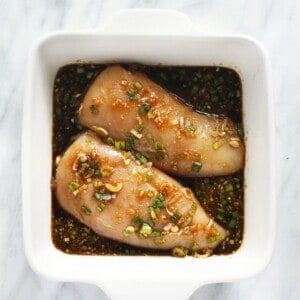 chicken marinating in dish.