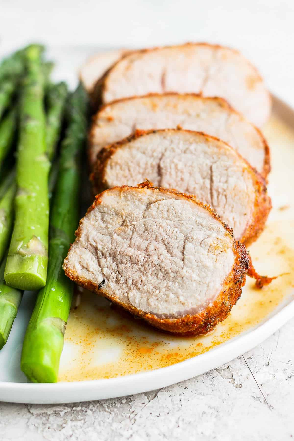 air fryer pork tenderloin sliced on a plate