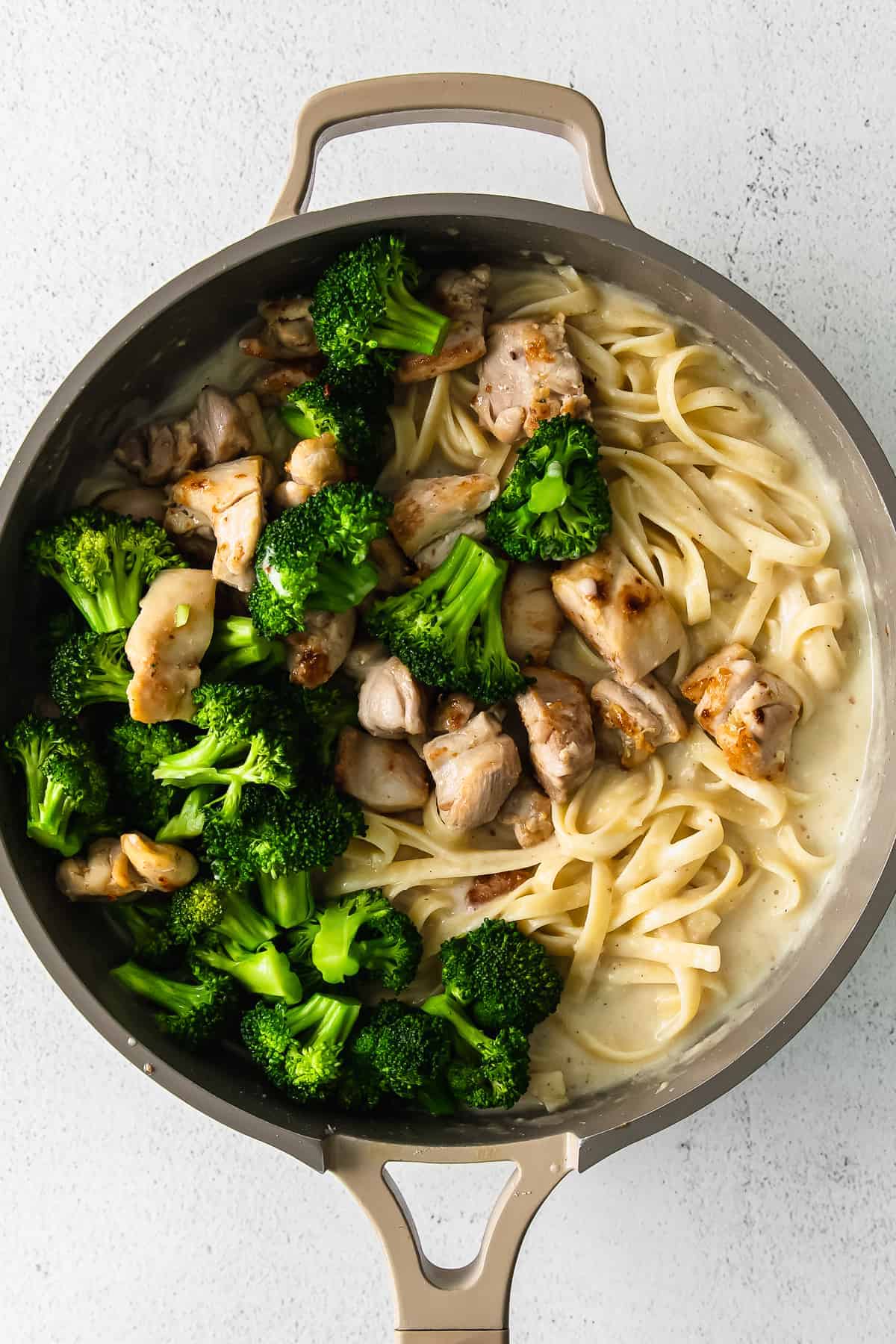 Chicken broccoli alfredo in a skillet pan. 