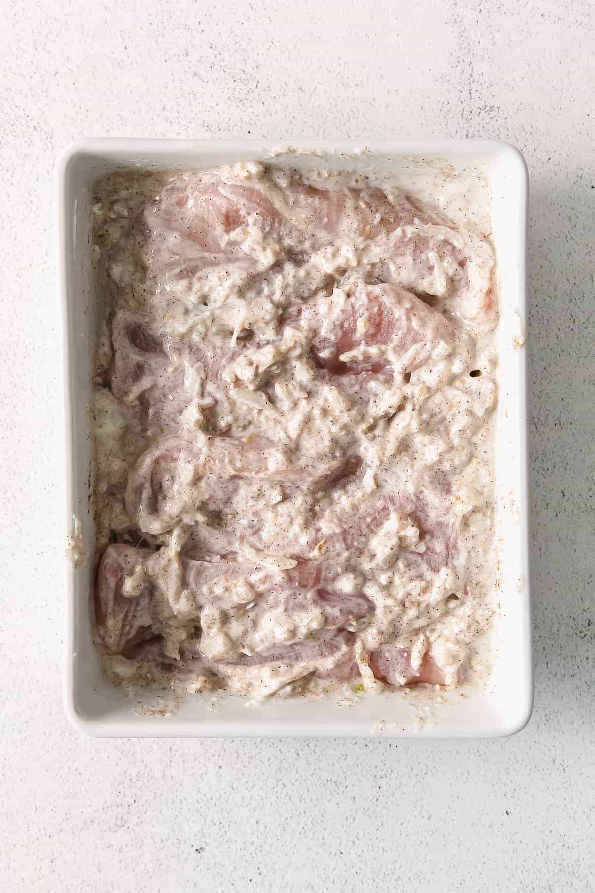 Chicken thighs marinating in Greek yogurt. 