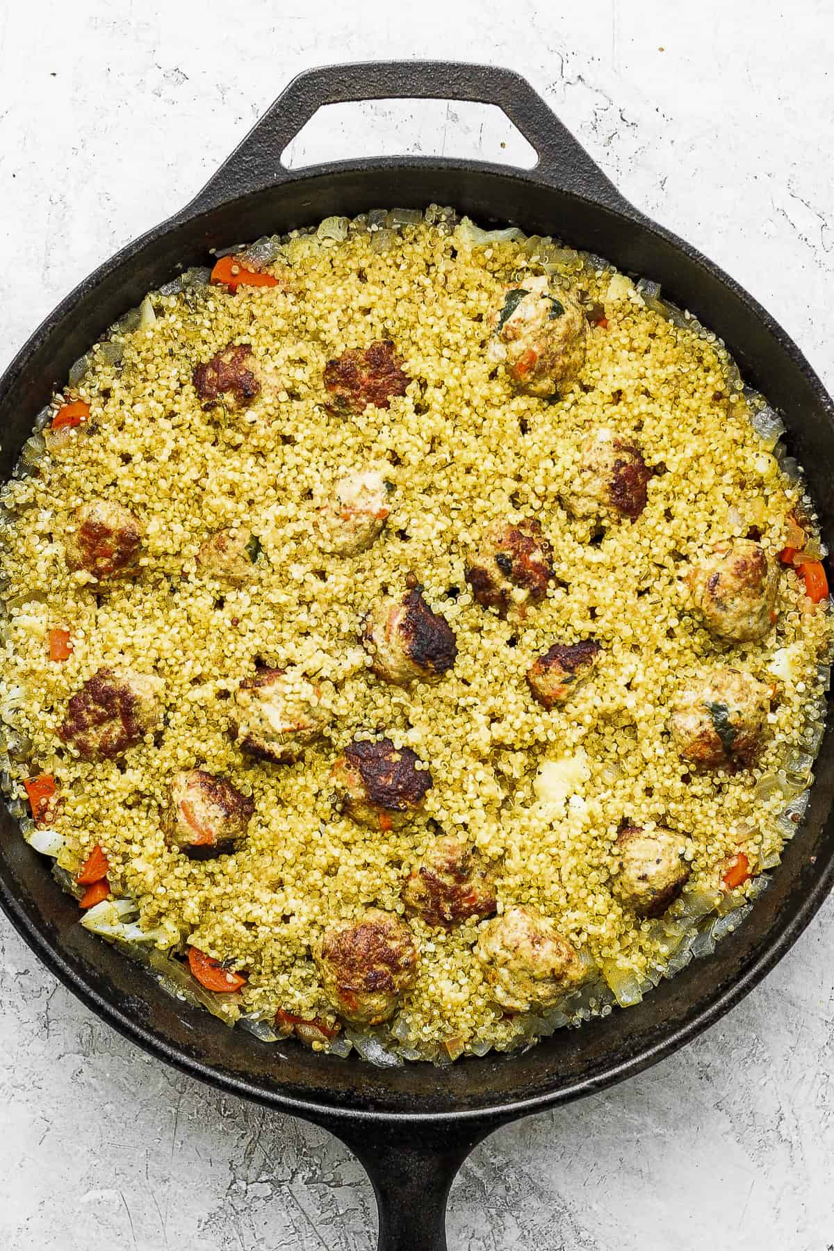 One-Pot Za'atar Meatballs and Quinoa ready to be topped with a delicious yogurt topping. 