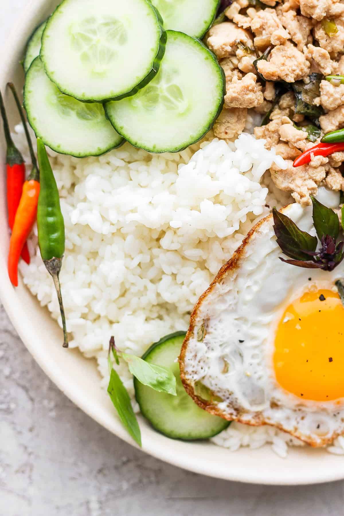 sticky rice paired with pad krapow in a bowl 