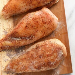 Broccoli and cheese stuffed chicken breasts on a cutting board.