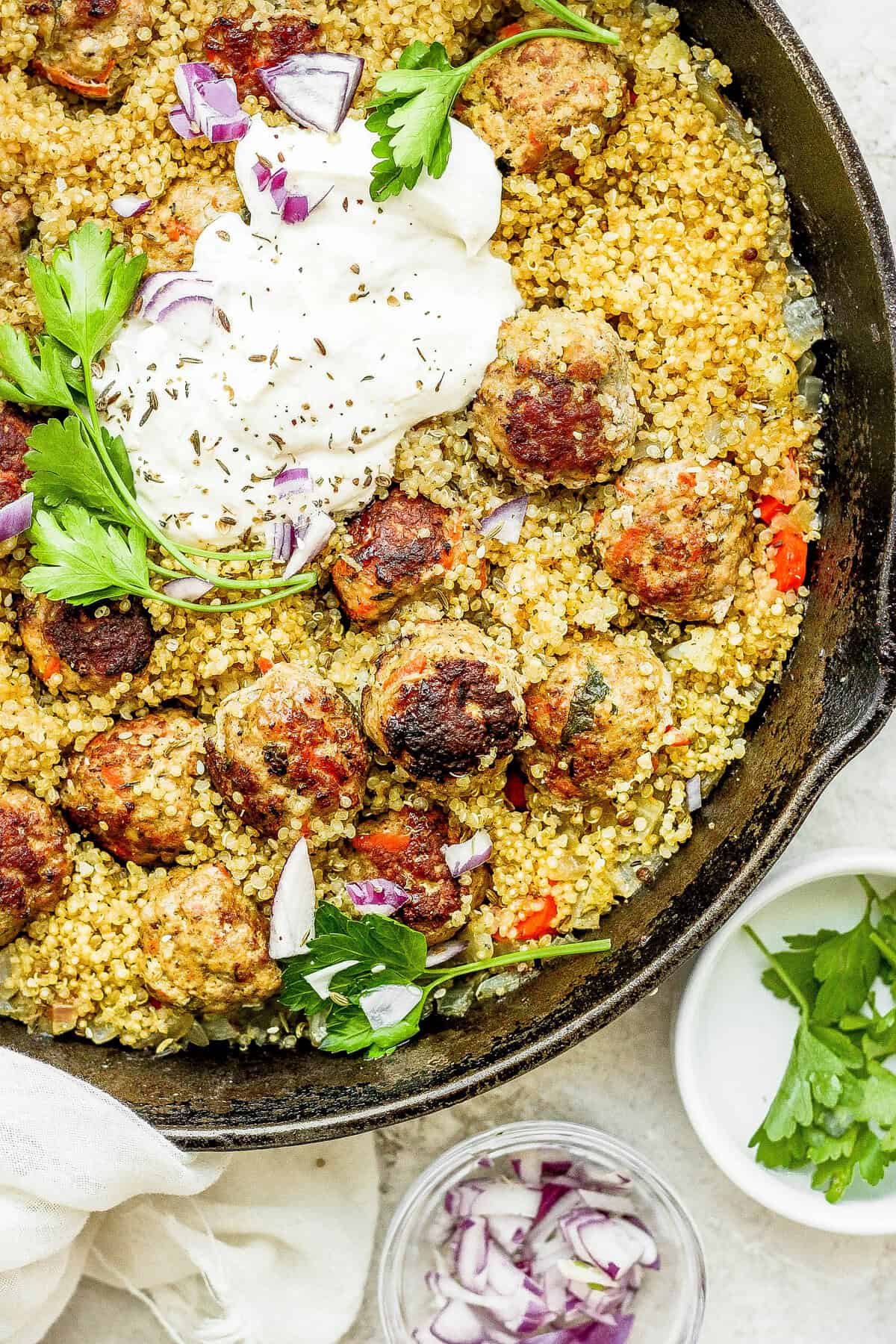 One-Pot Za'atar Meatballs and Quinoa topped with a lemon yogurt sauce. 