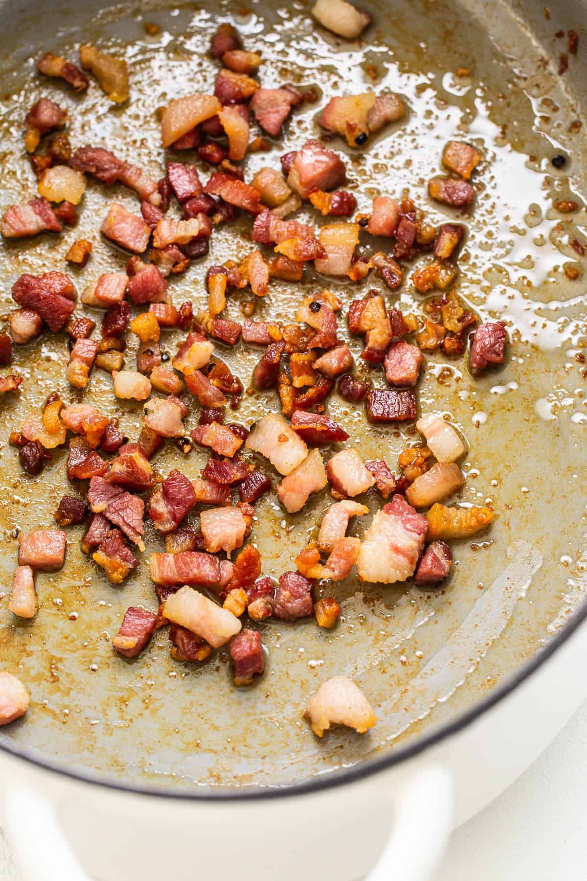 Pancetta sautéing in a dutch oven.