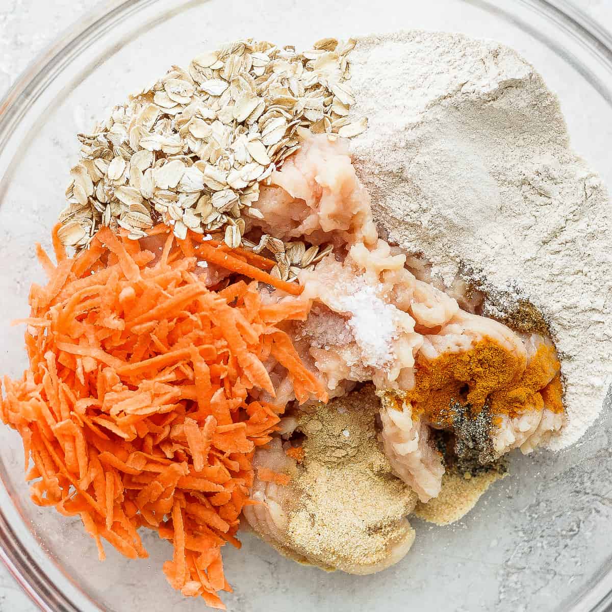 All of the ingredients for these chicken meatballs in a mixing bowl. 