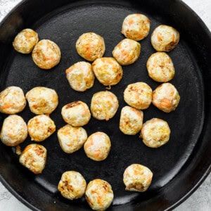 Browning chicken meatballs in the cast iron skillet.