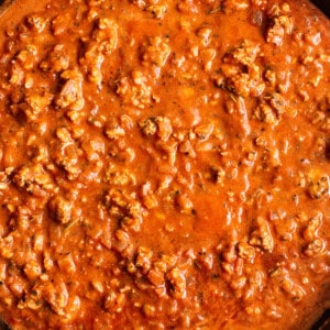 A skillet filled with meat and sauce.