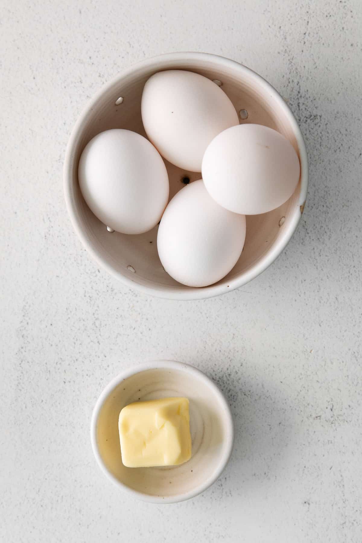 4 large eggs in a white bowl. 