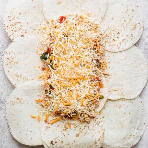 All the toppings for the sheet pan quesadillas on top of the tortillas.