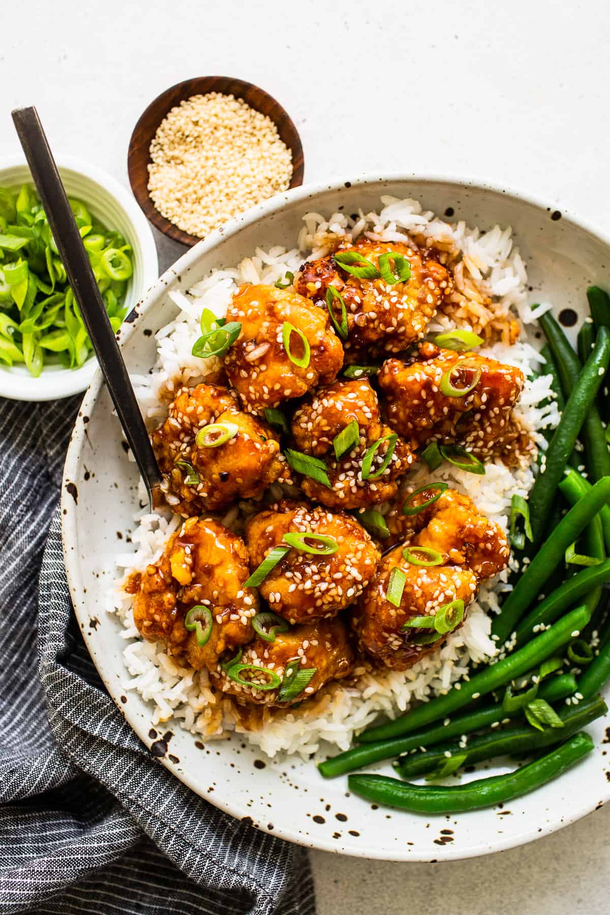 sesame chicken in bowl with veggies