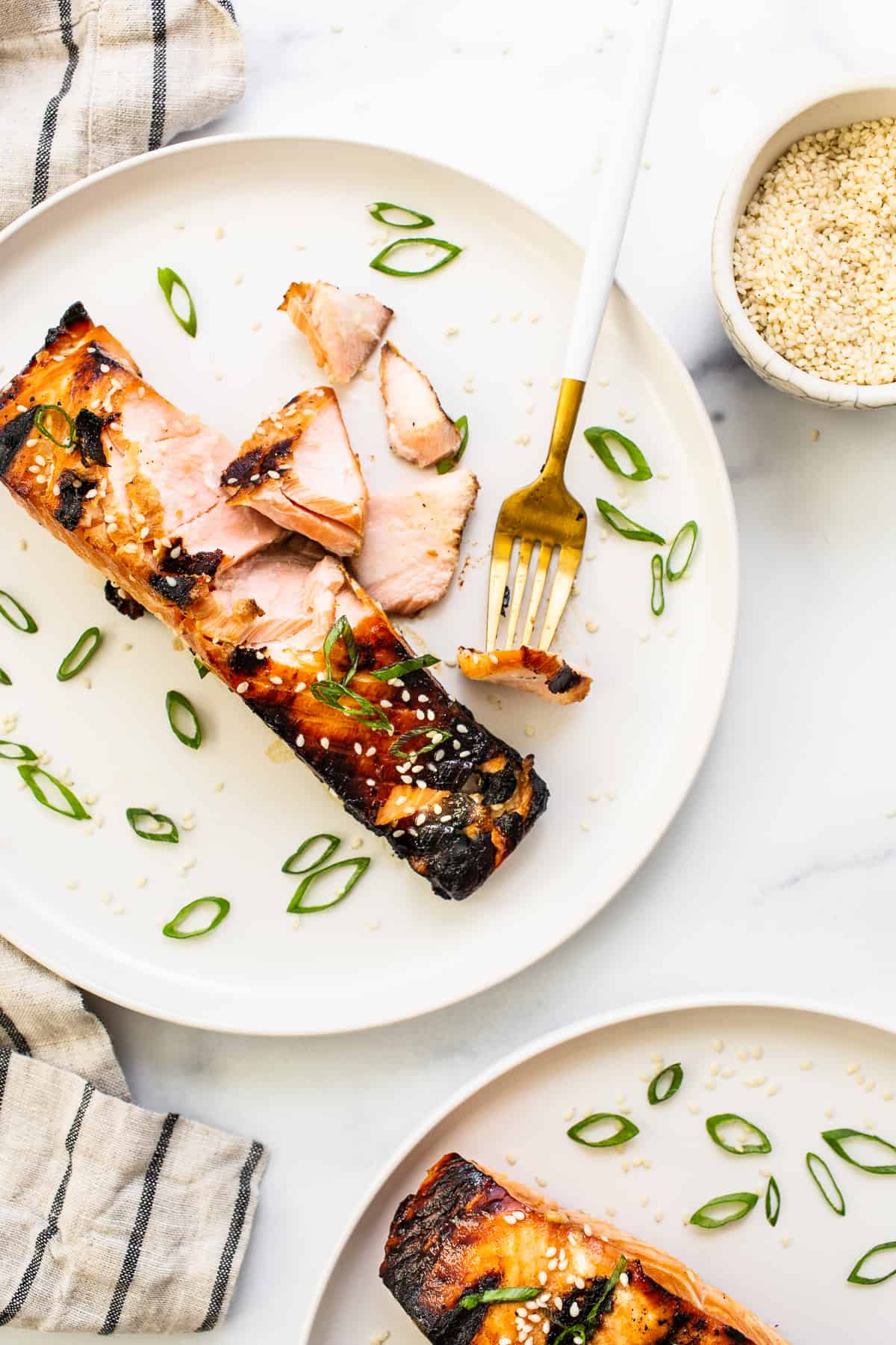 flakey salmon with fork on plate.