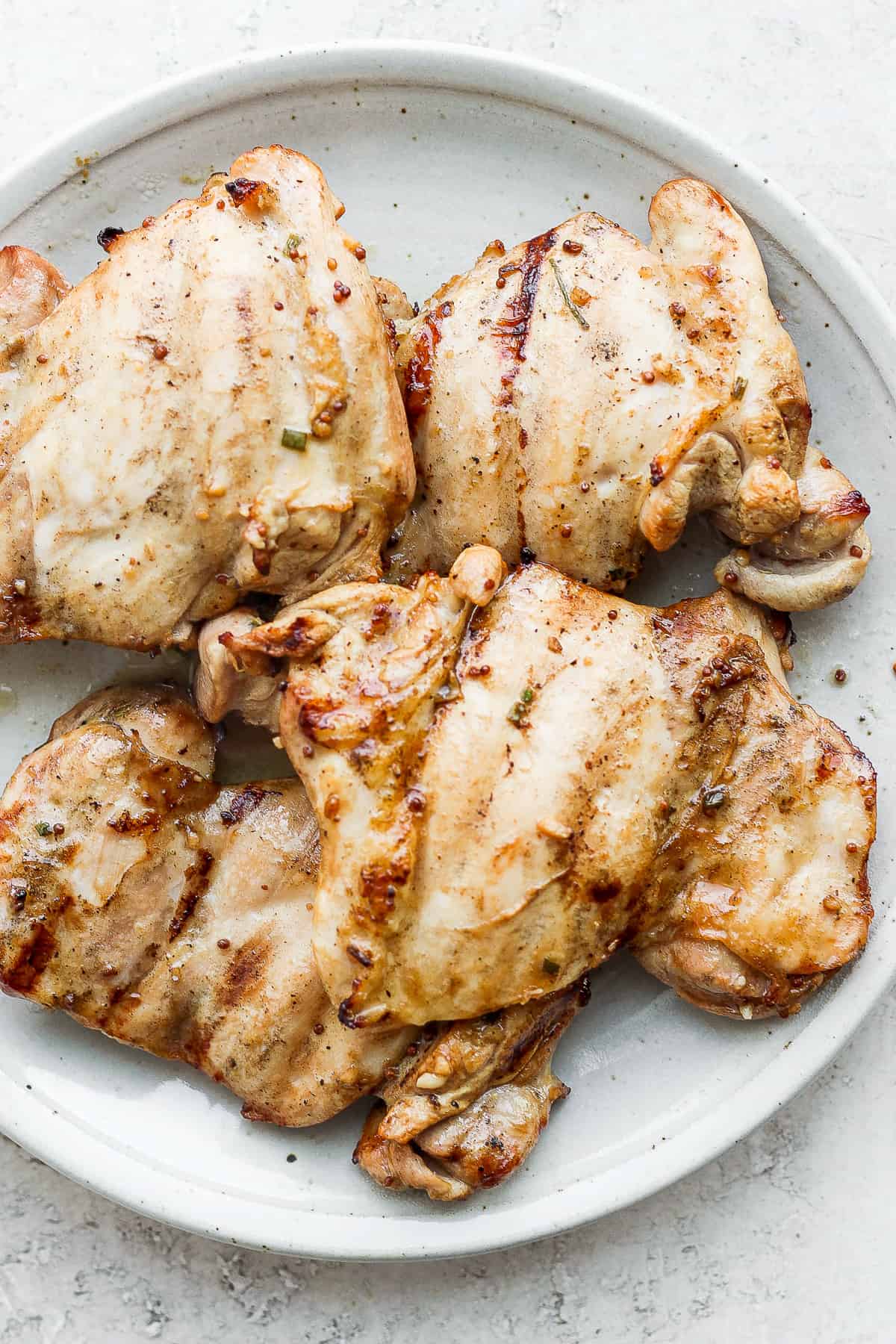 Chicken thighs on plate.