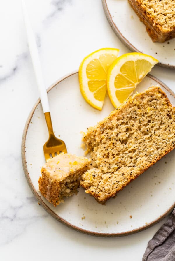 A piece of lemon poppy seed bread on a plate.