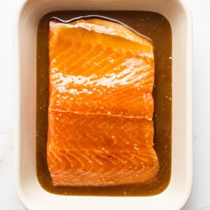 Maple mustard smoked salmon marinating in a dish.